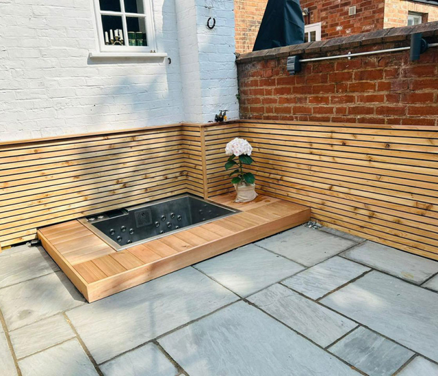 Bespoke compact 2-seater hot tub designed to fit a small unusable space in a garden