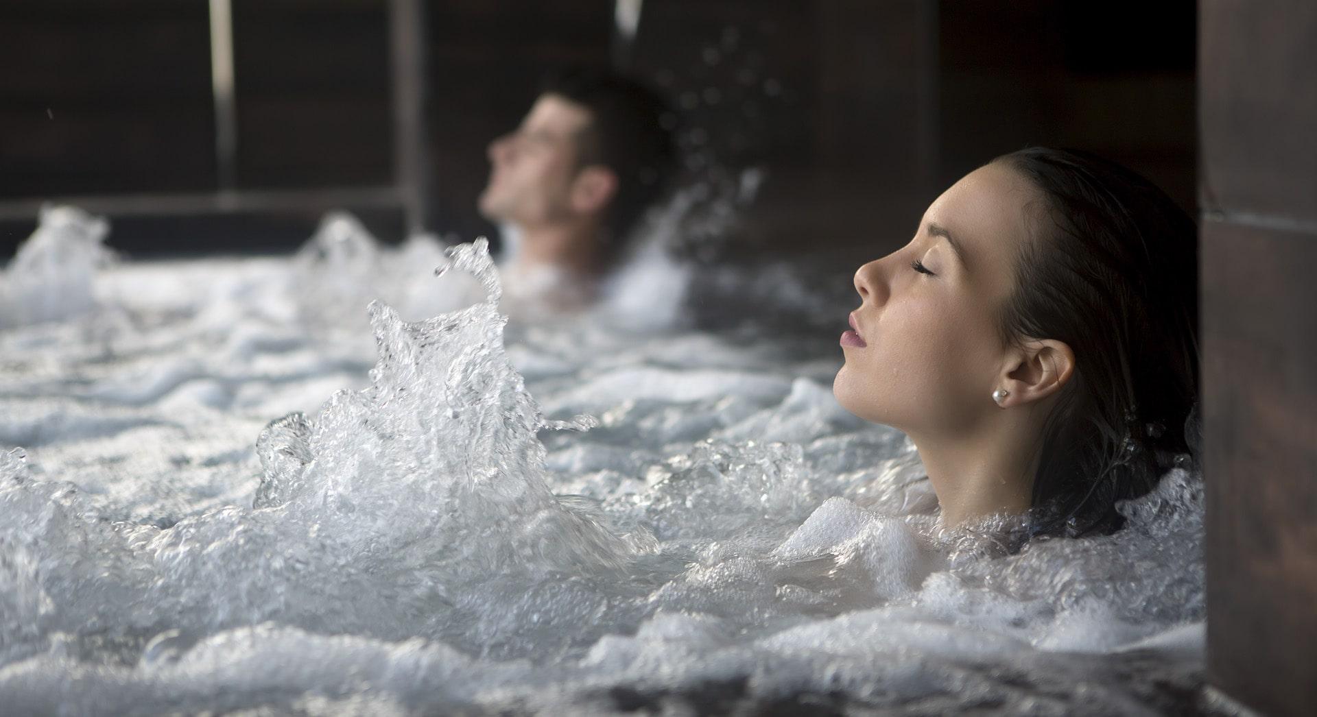 man and woman relaxing in a bespoke stainless steel hydrotherapy pool