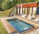 Stainless steel swim spa installed sunken under decking in a garden