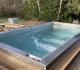 Stainless steel hot tub with solid wood surround