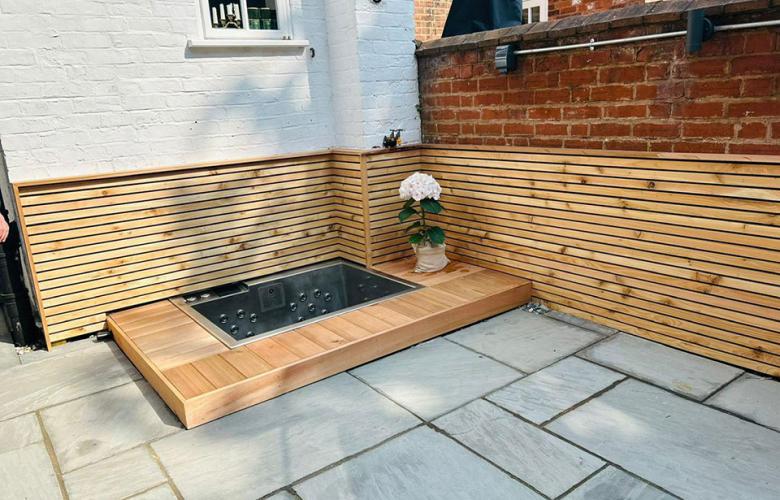 Bespoke compact 2-seater hot tub designed to fit a small unusable space in a garden