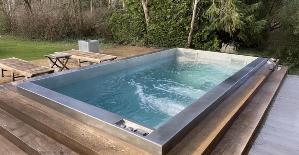 Stainless steel hot tub with solid wood surround